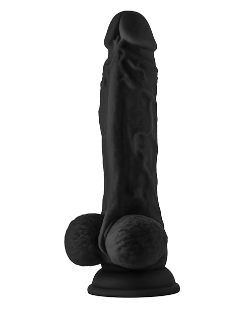 Black silicone dildo on a white background